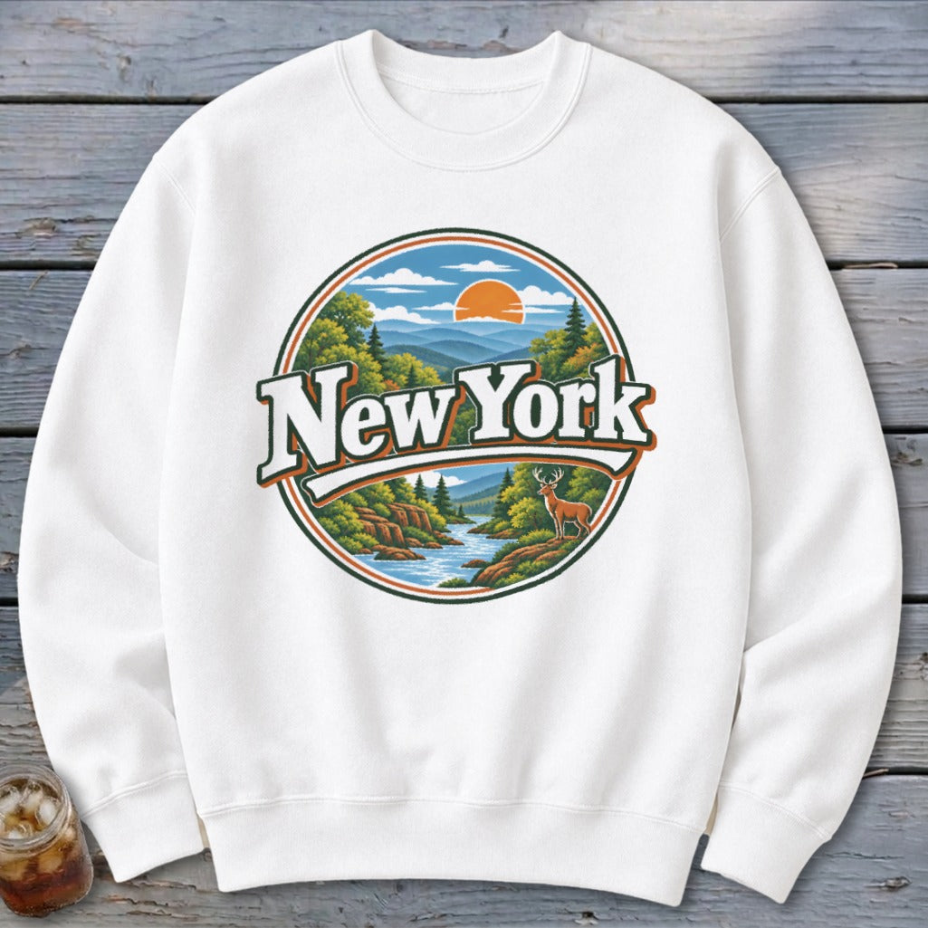 White sweatshirt with a circular graphic featuring "New York" text and a landscape with a deer.