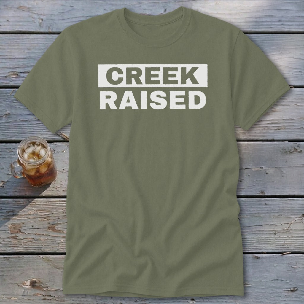 Olive green t-shirt with "CREEK RAISED" in white block letters.