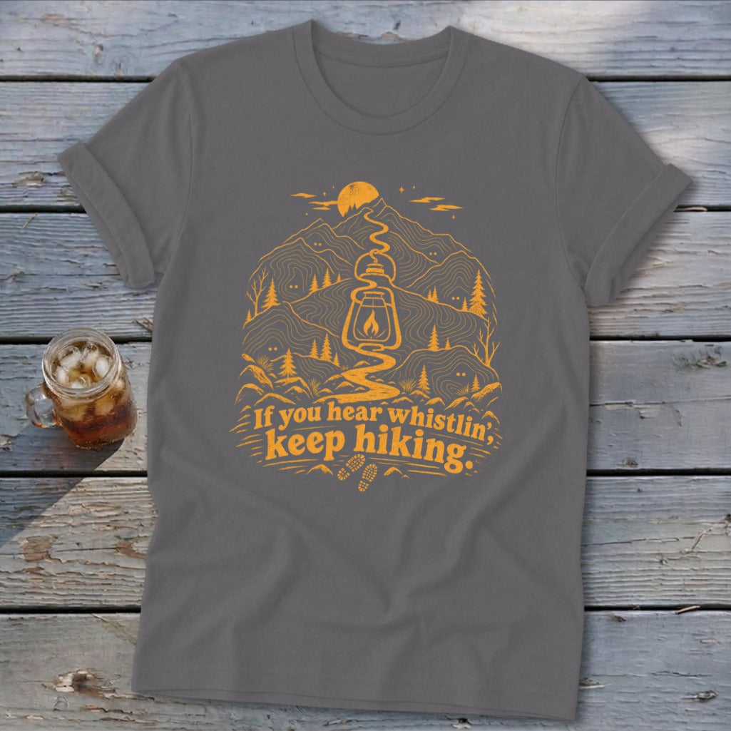 Gray t-shirt with orange hiking graphic and text "If you hear whistlin', keep hiking."