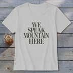 Light grey V-neck t-shirt with dark grey text "WE SPEAK MOUNTAIN HERE".
