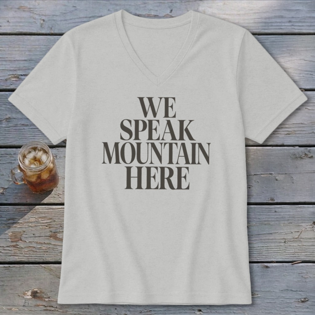 Light grey V-neck t-shirt with dark grey text "WE SPEAK MOUNTAIN HERE".