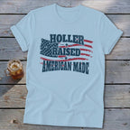 Light blue t-shirt with distressed American flag graphic and text "HOLLER RAISED AMERICAN MADE".