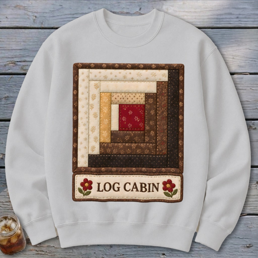 White sweatshirt with a central log cabin quilt square and "LOG CABIN" text.