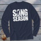 A navy blue long-sleeve t-shirt with white distressed text that reads SANG SEASON and a silhouetted digger.