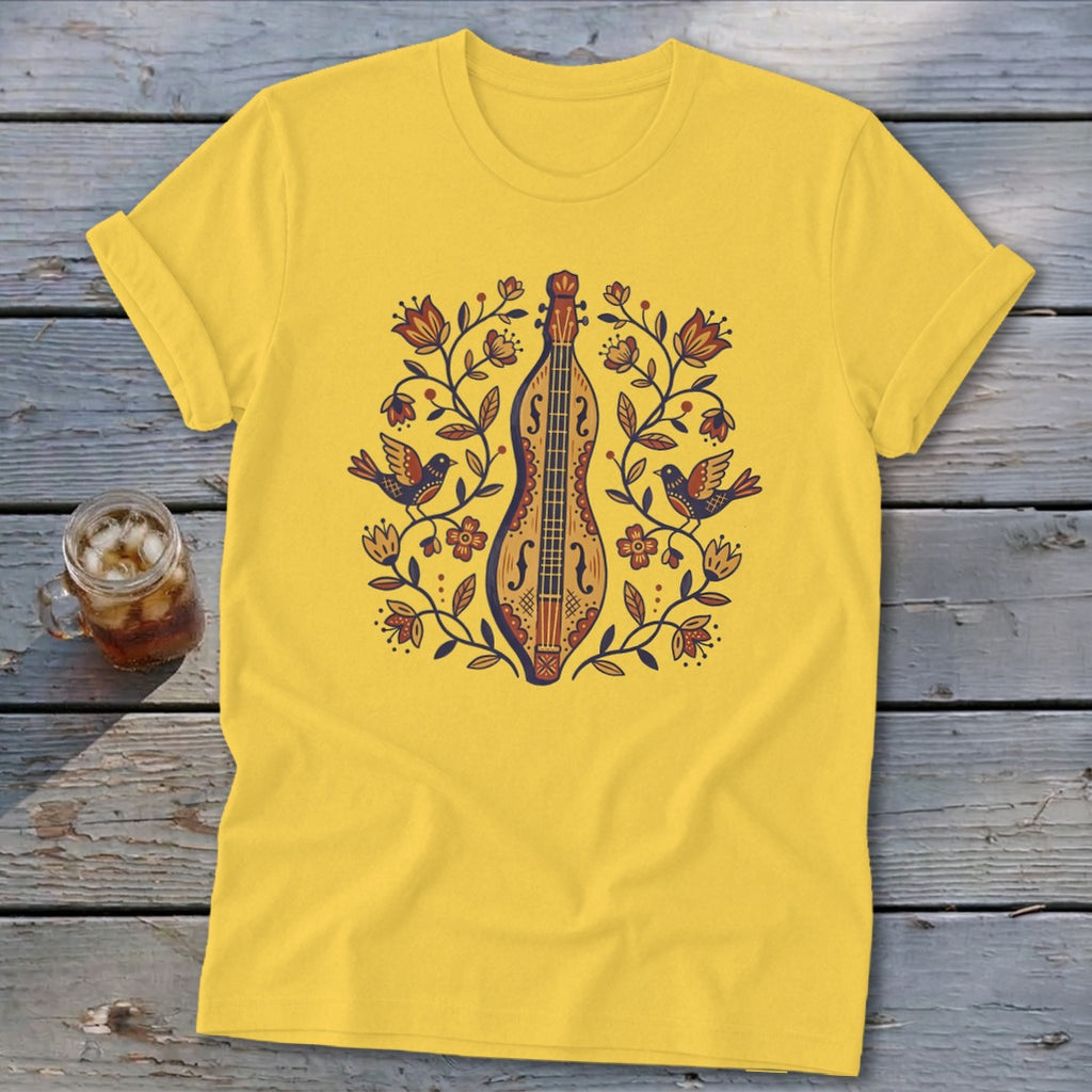 Yellow t-shirt with folk art design of a dulcimer, birds, and floral elements.