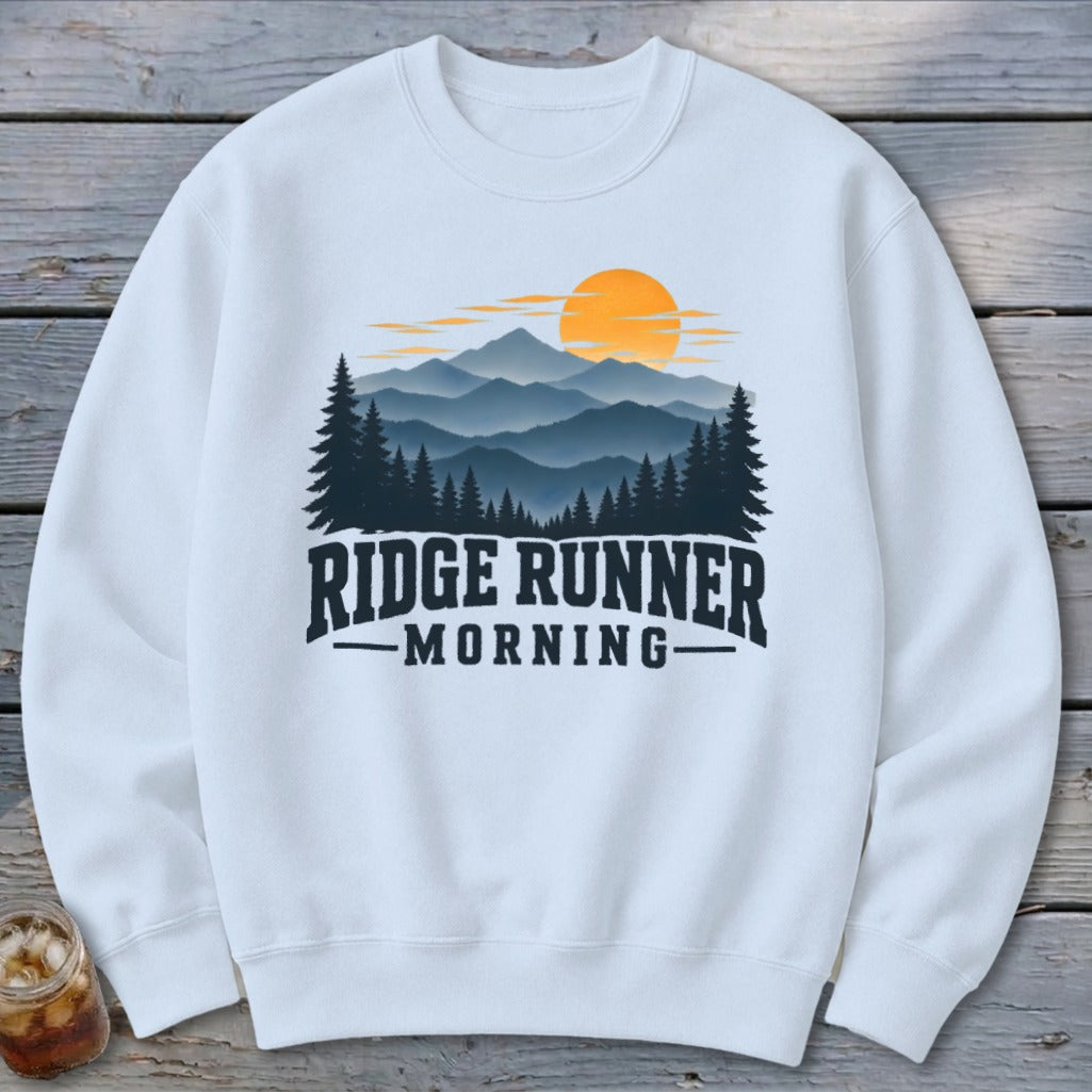 White sweatshirt with mountain and sunrise graphic and text "RIDGE RUNNER MORNING".