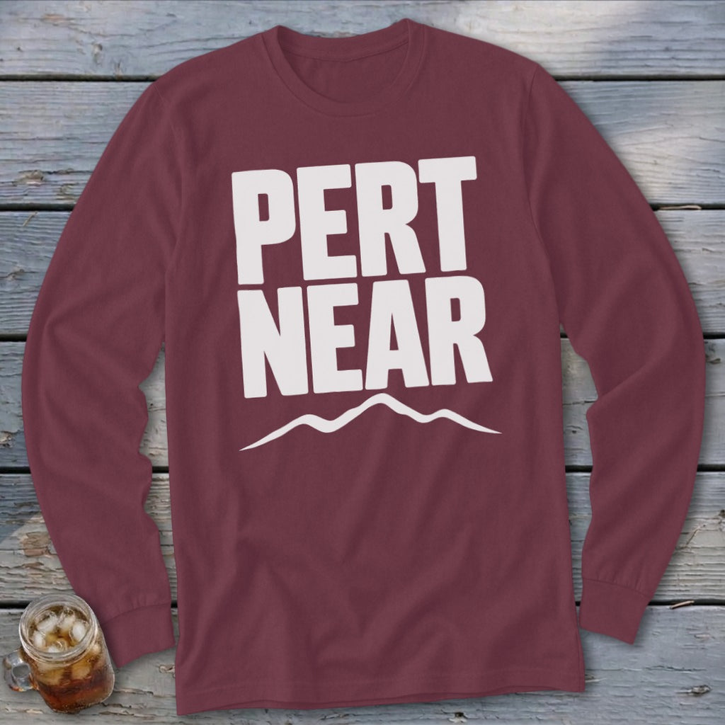 Maroon long-sleeve t-shirt with white text reading PERT NEAR above a mountain range graphic.