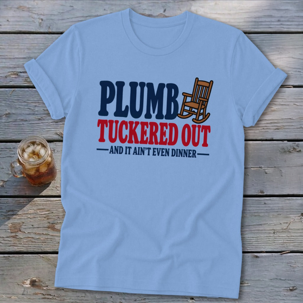 Light blue t-shirt with text "PLUMB TUCKEREED OUT AND IT AIN'T EVEN DINNER".