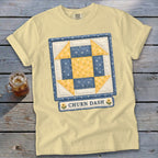 Yellow t-shirt with a blue and yellow quilt square graphic and "CHURN DASH" text.