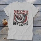 Light gray t-shirt featuring a red and black banjo graphic with the text Old Sounds New Ground.