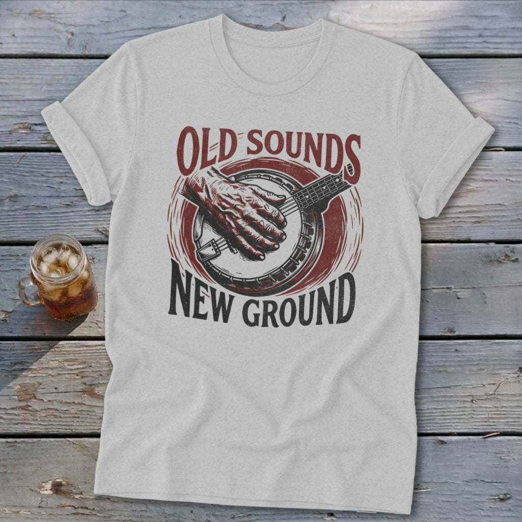 Light gray t-shirt featuring a red and black banjo graphic with the text Old Sounds New Ground.
