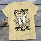 T-shirt graphic with text "Barefoot on the Crick Bank" and drawn feet in water.