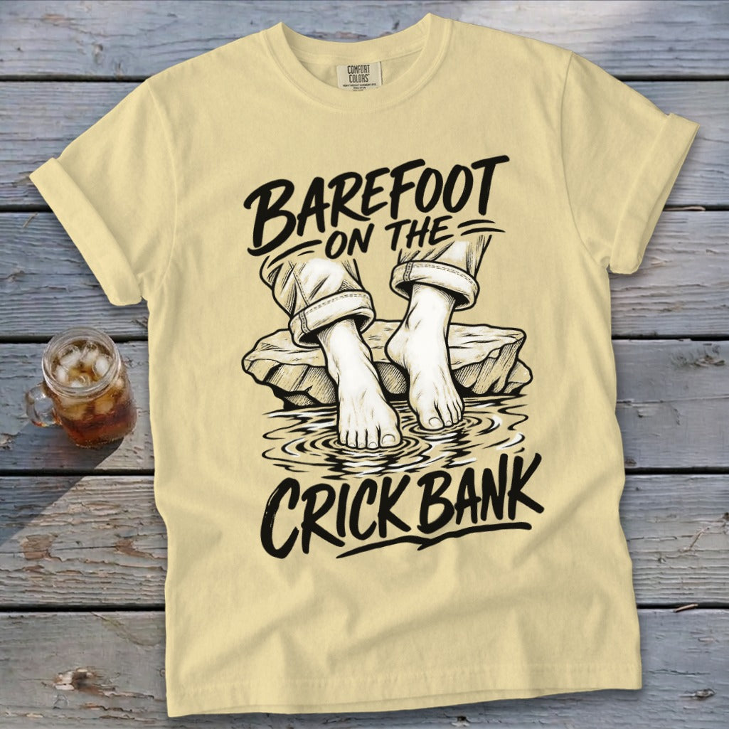T-shirt graphic with text "Barefoot on the Crick Bank" and drawn feet in water.