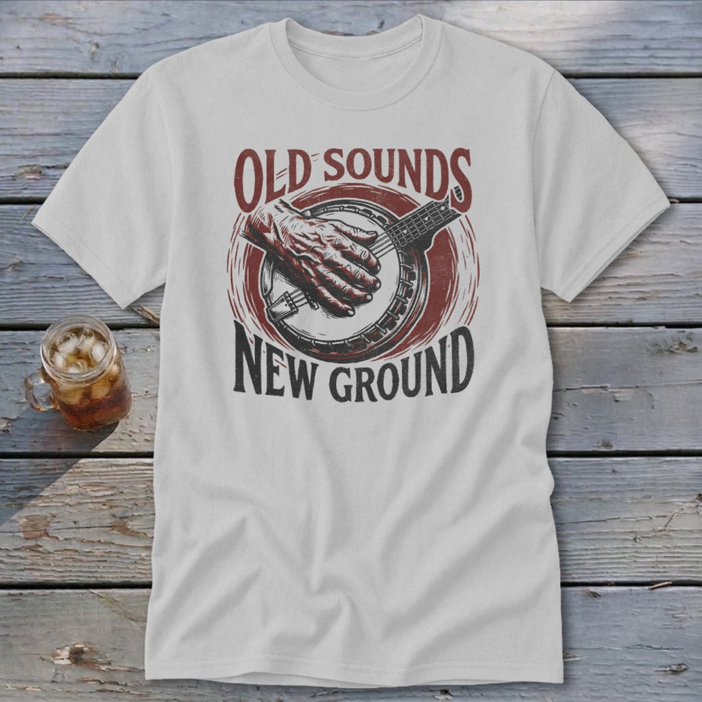 Light gray t-shirt with a vintage graphic of a hand playing a banjo and text reading Old Sounds New Ground.