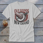 Light gray t-shirt with a vintage graphic of a hand playing a banjo and text reading Old Sounds New Ground.
