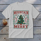 Light gray t-shirt featuring a green Christmas tree graphic and the text Mountain Merry.