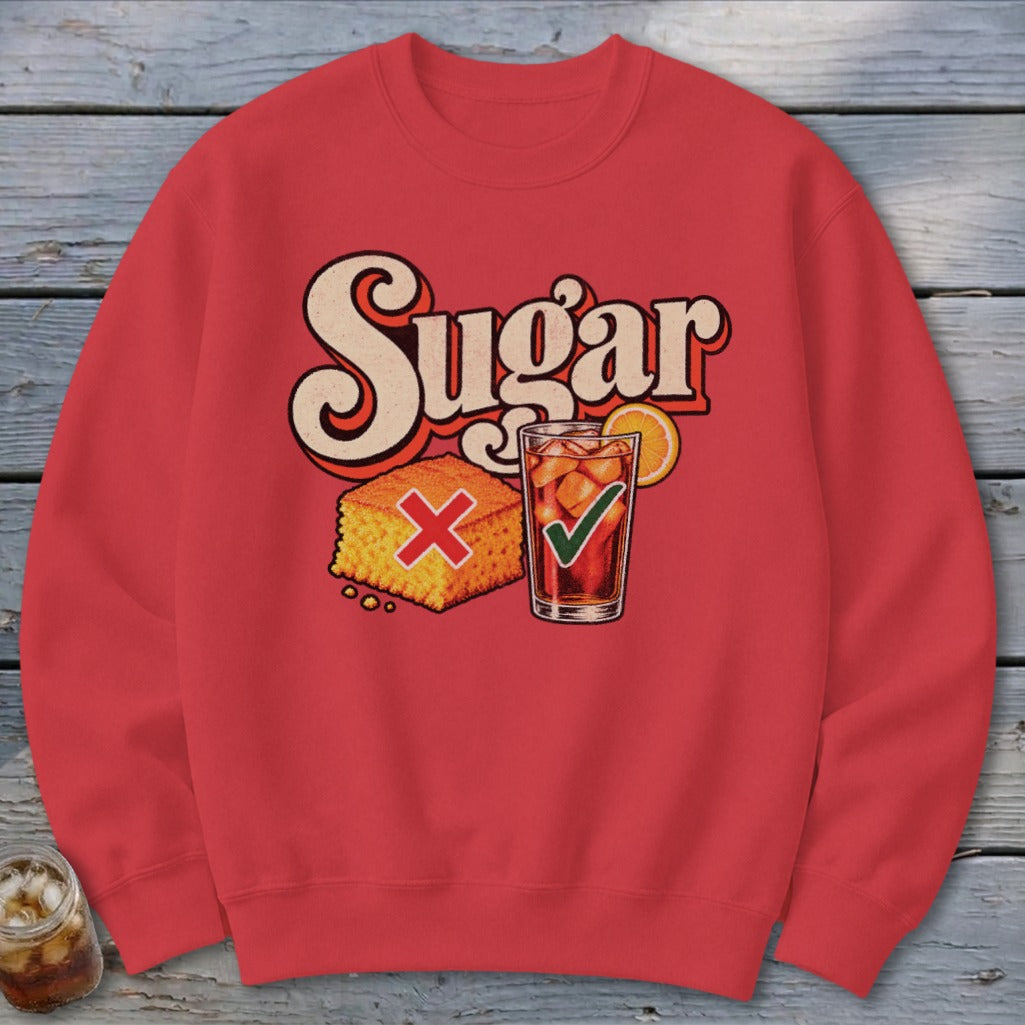 Red crewneck sweatshirt featuring a graphic of cornbread with a red X and iced tea with a green checkmark below the word Sugar.