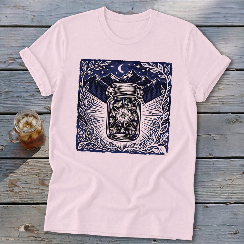 T-shirt with a dark blue design of fireflies in a jar under a starry night sky.