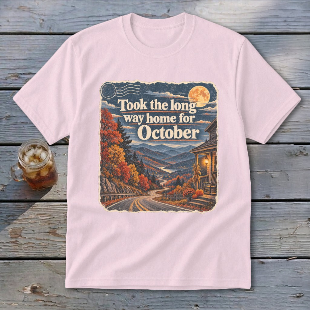 Pink t-shirt with "Took the long way home for October" graphic and autumn mountain scene.