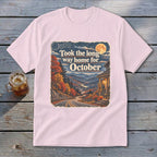 Pink t-shirt with "Took the long way home for October" graphic and autumn mountain scene.