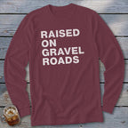 Maroon long-sleeve shirt with "RAISED ON GRAVEL ROADS" text in white.