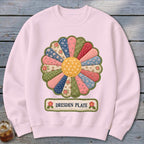 Pink sweatshirt featuring a Dresden Plate floral applique and text.