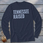Navy long-sleeve t-shirt with "TENNESSEE RAISED" in light blue text.