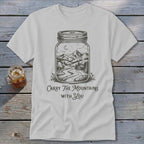 Light gray t-shirt featuring a mason jar graphic of a mountain landscape and text reading Carry The Mountains With You.