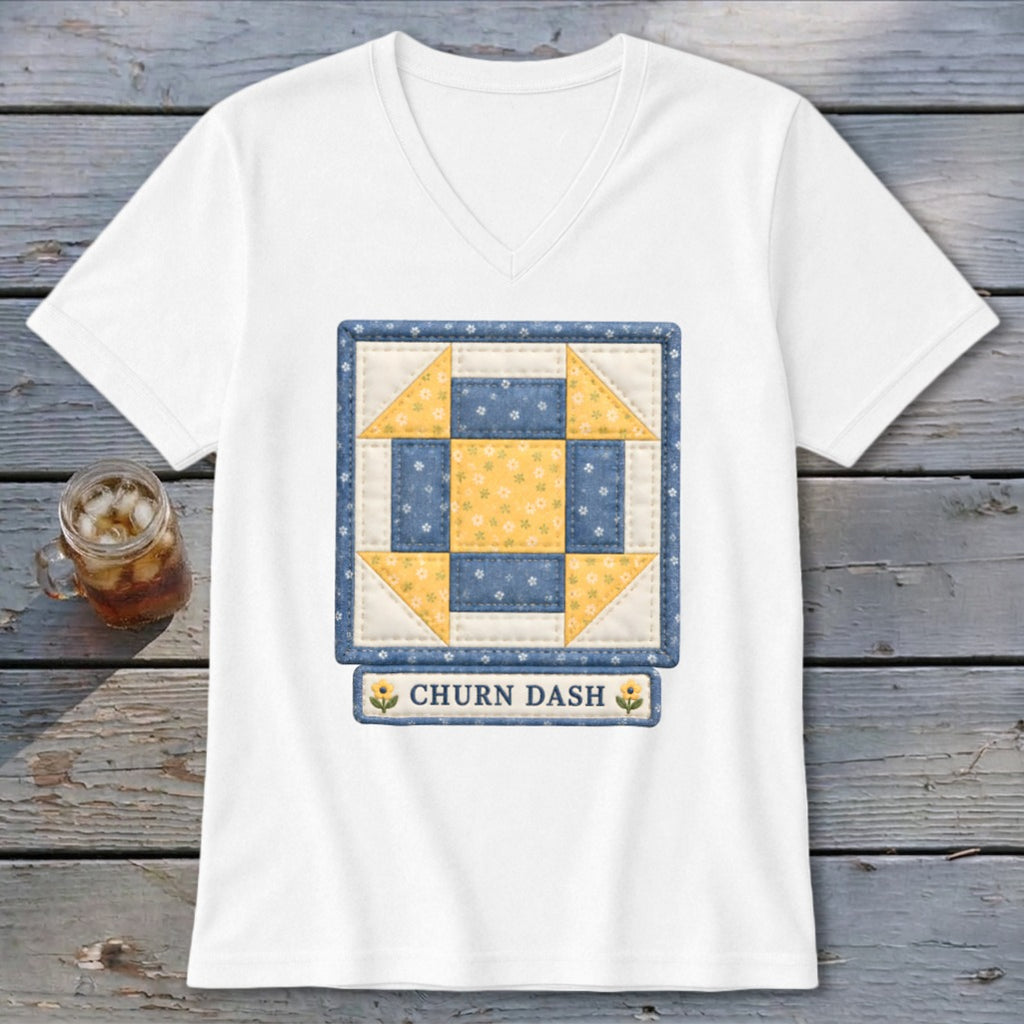White t-shirt with a blue and yellow "Churn Dash" quilt block design.