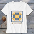 White t-shirt with a blue and yellow "Churn Dash" quilt block design.