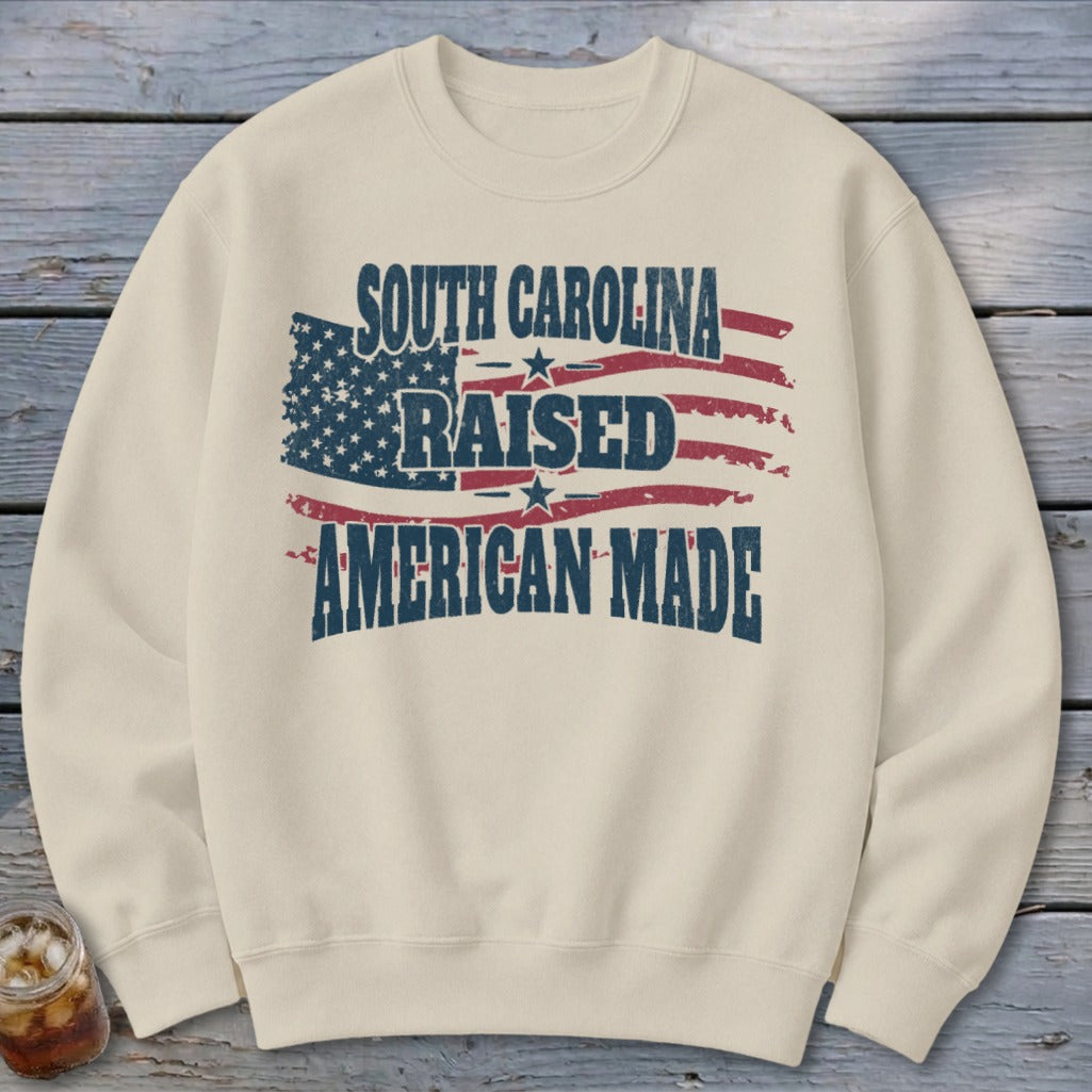 Cream sweatshirt with distressed American flag graphic and text.