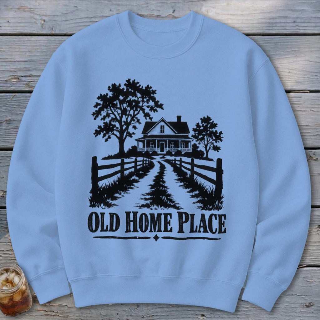 Light blue sweatshirt with black graphic of a farmhouse, trees, and text "OLD HOME PLACE."