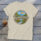 Cream t-shirt with circular Tennessee landscape graphic featuring mountains, river, trees, and a deer.