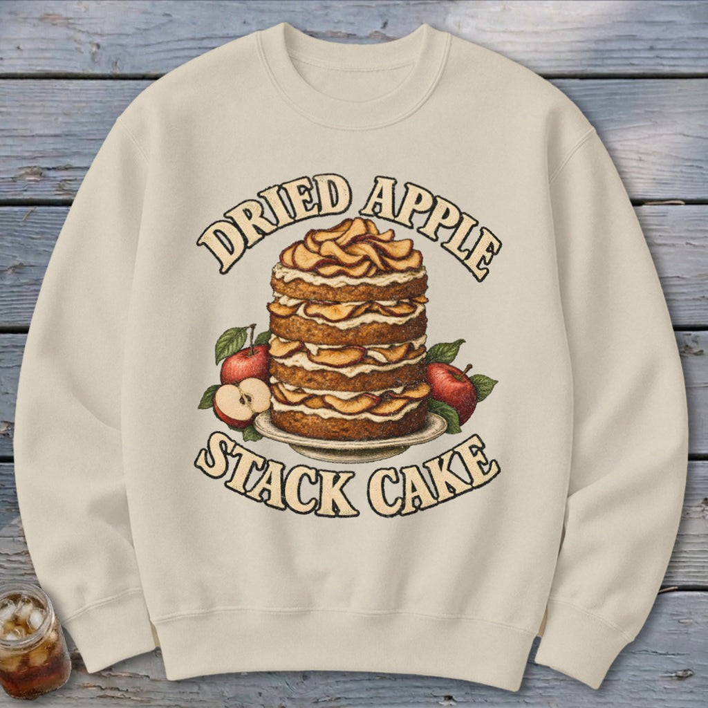Cream sweatshirt with a "Dried Apple Stack Cake" graphic featuring a tall cake and apples.