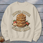 Cream sweatshirt with a "Dried Apple Stack Cake" graphic featuring a tall cake and apples.