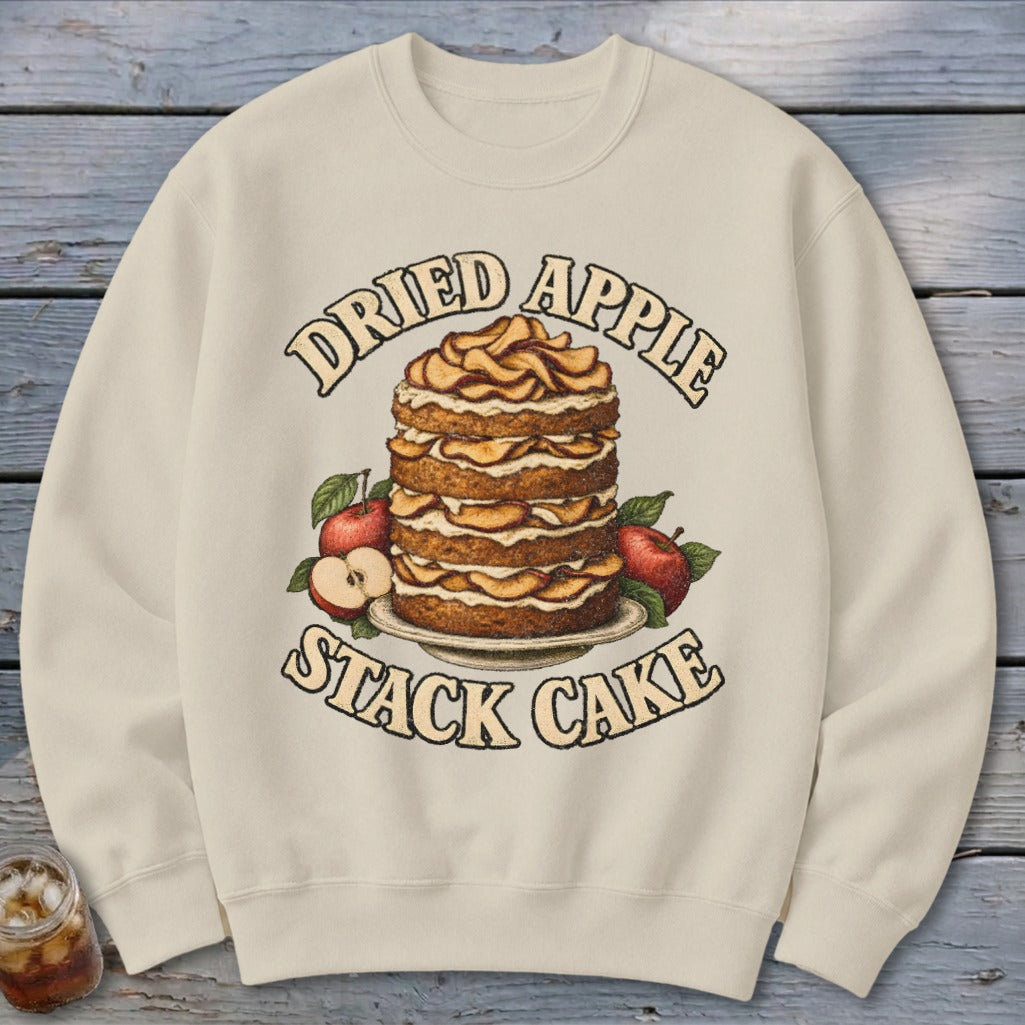 Cream sweatshirt with a "Dried Apple Stack Cake" graphic featuring a tall cake and apples.