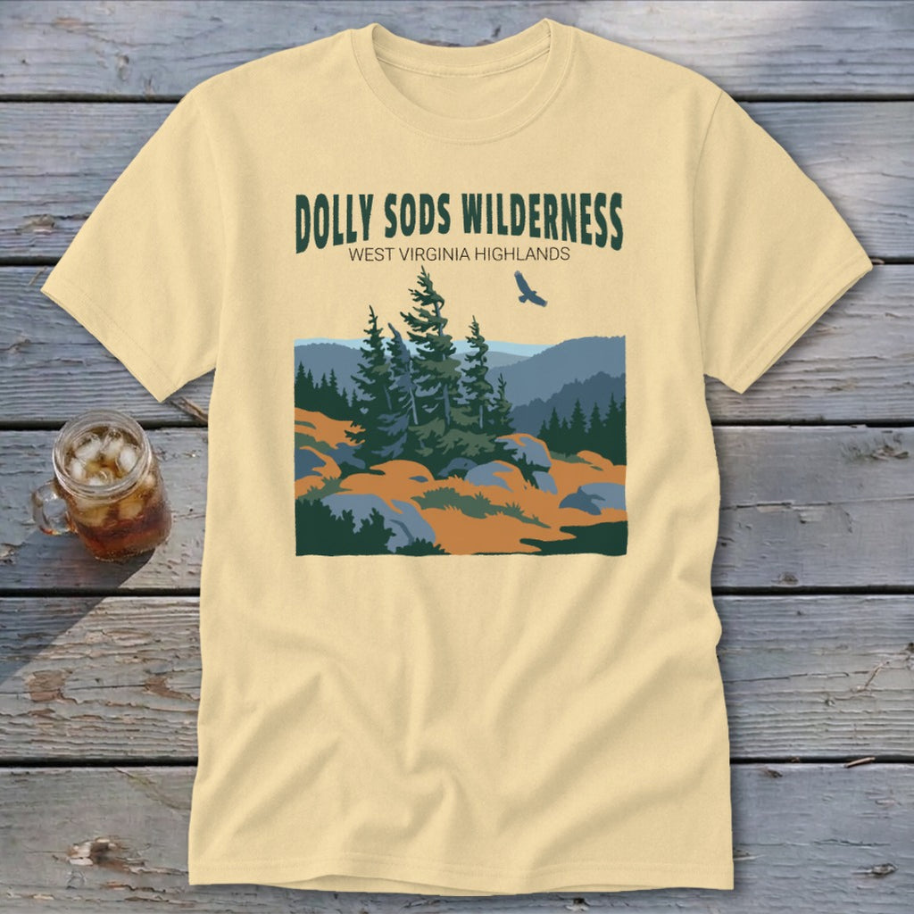 Light yellow t-shirt featuring a green graphic of Dolly Sods Wilderness with pine trees and a flying bird.