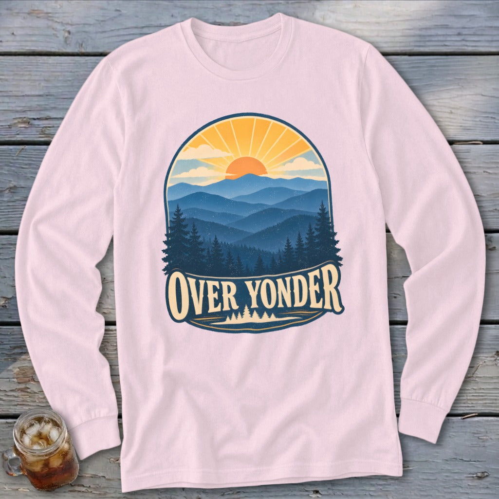 Light pink long-sleeve t-shirt featuring a retro mountain landscape graphic with the text Over Yonder.