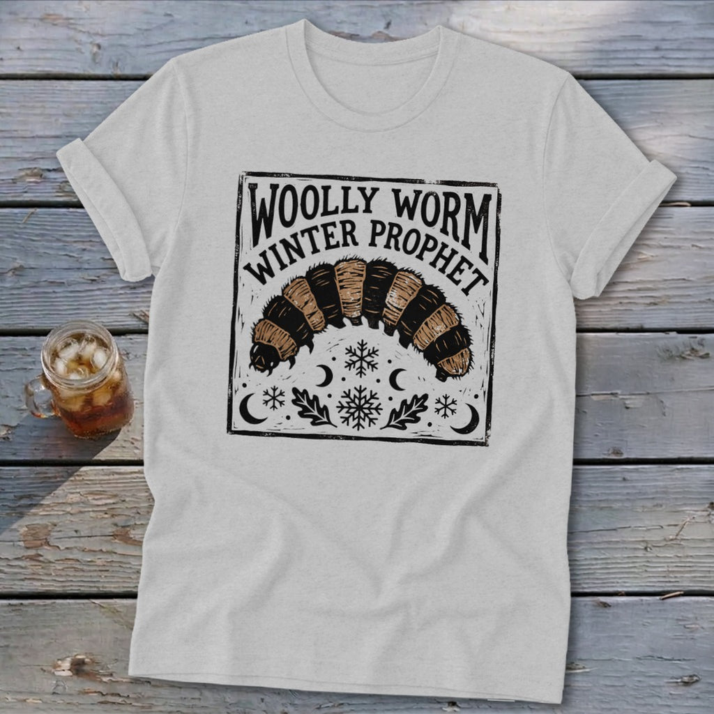 A light gray crewneck t-shirt featuring a black and brown woolly worm graphic with text that reads Woolly Worm Winter Prophet.