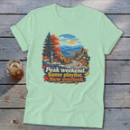 Light green t-shirt with autumn mountain overlook graphic and text.