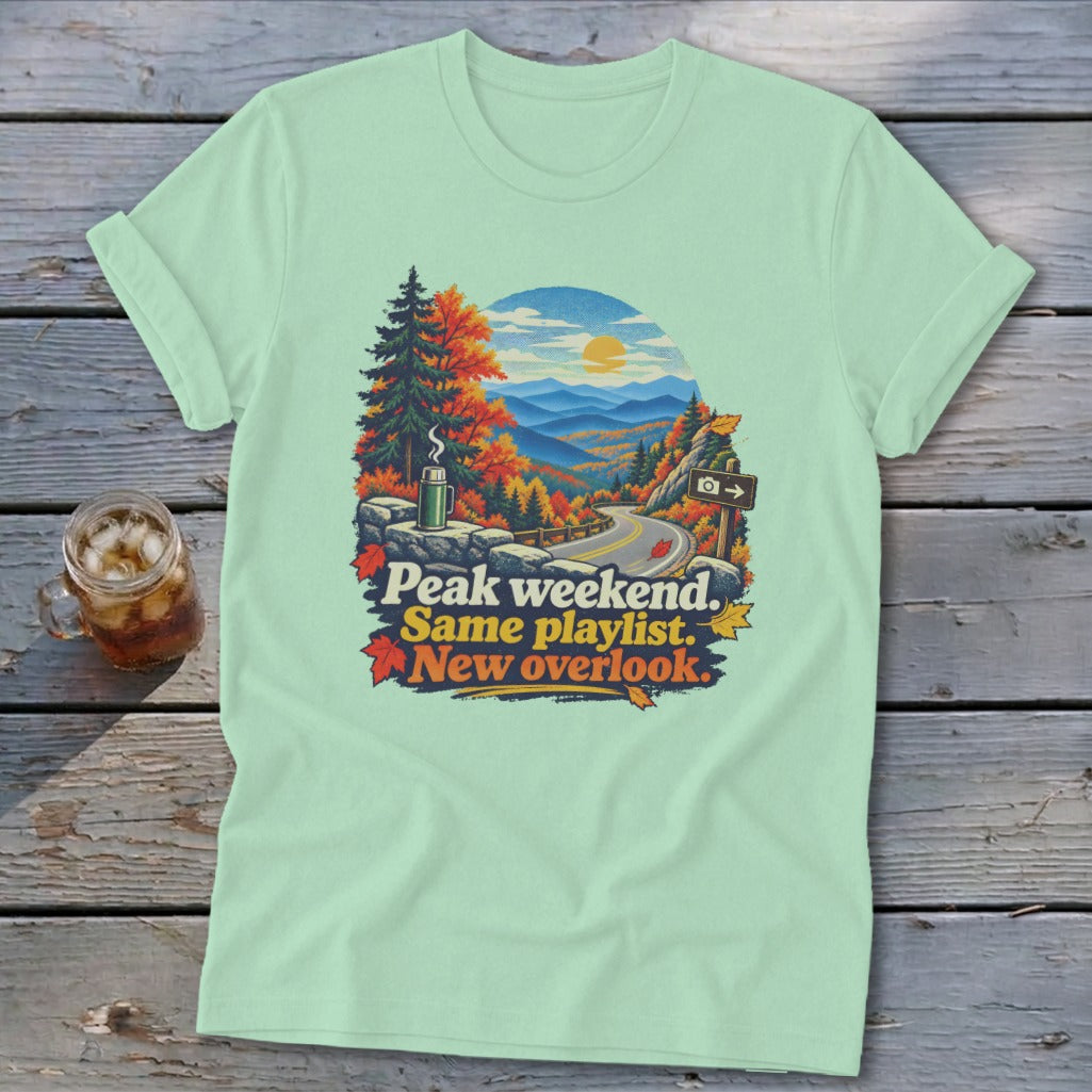Light green t-shirt with autumn mountain overlook graphic and text.