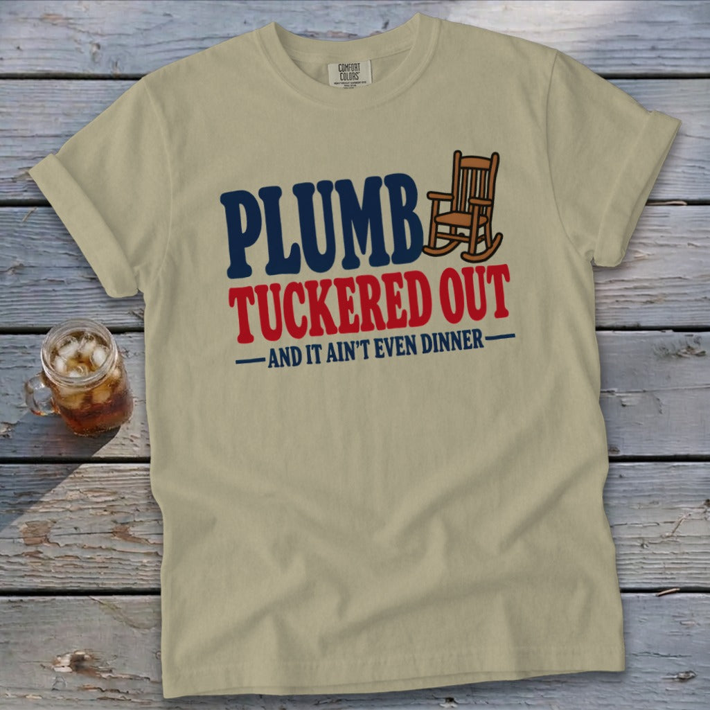 Tan t-shirt with "PLUMB TUCKERED OUT -AND IT AIN'T EVEN DINNER-" text and rocking chair.