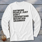 White long-sleeve shirt with black text that reads "anymore people just don't understand mountain grammar".