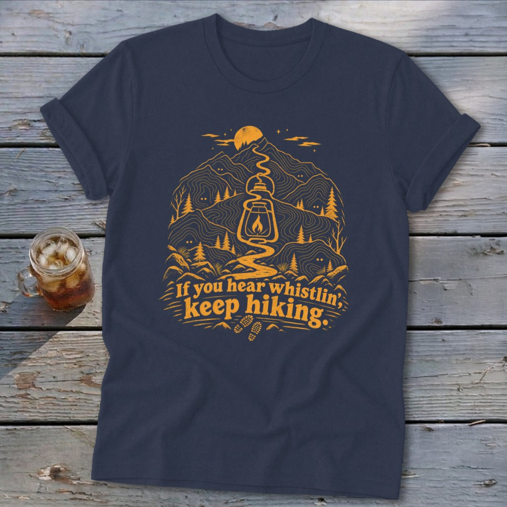 Navy t-shirt with orange mountain graphic, lantern, and text "If you hear whistlin', keep hiking."