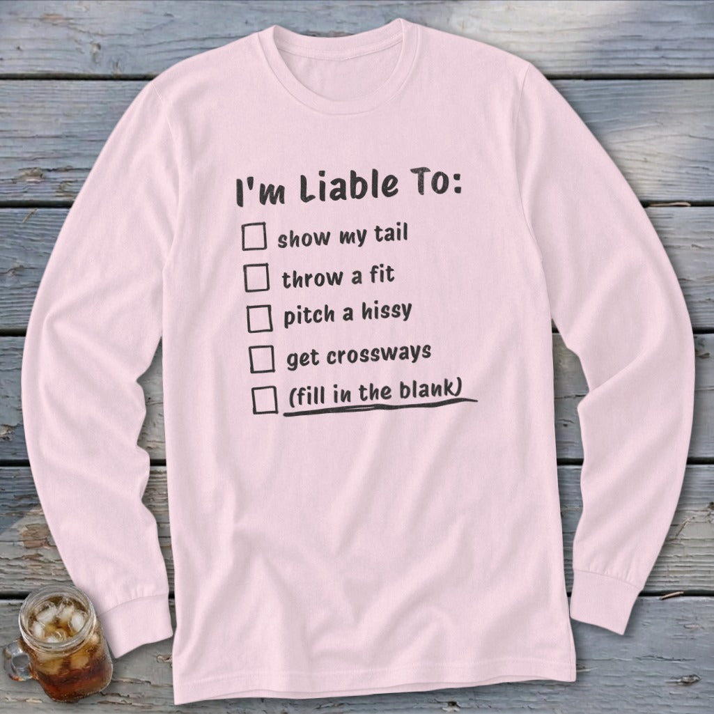 Pink long sleeve shirt with "I'm Liable To:" and a checklist of humorous actions.