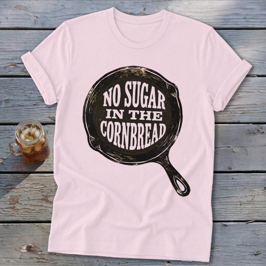 Pink t-shirt with "NO SUGAR IN THE CORNBREAD" text inside a skillet graphic.