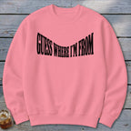 Pink sweatshirt with black text that reads "GUESS WHERE I'M FROM".