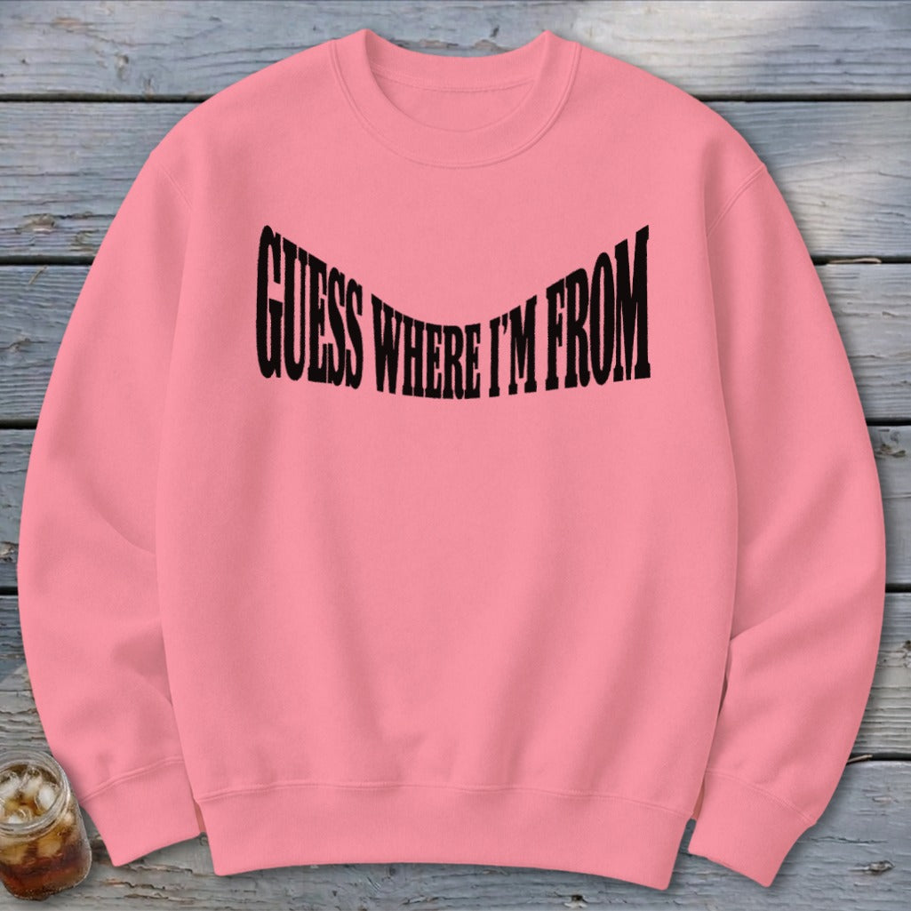 Pink sweatshirt with black text that reads "GUESS WHERE I'M FROM".