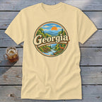 Cream t-shirt with a circular Georgia mountain landscape graphic and a deer.