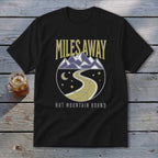 Black t-shirt with "Miles Away But Mountain Bound" text and mountain graphic.